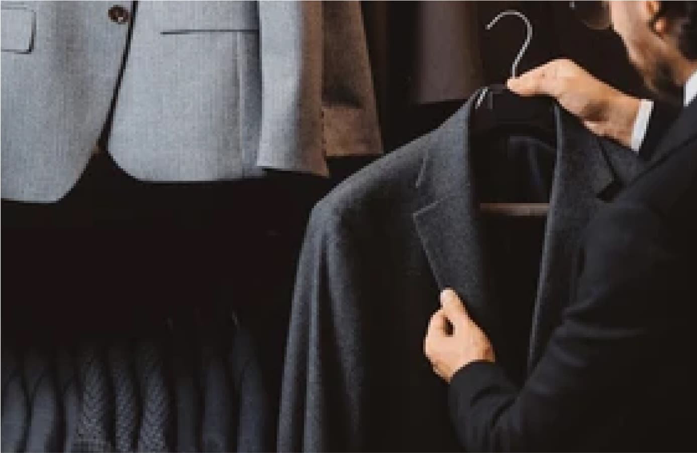 Tailor inspecting handcrafted details on a Deletto Milano suit