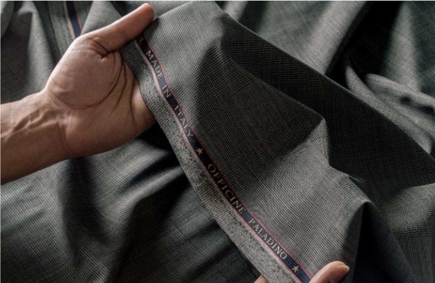 Artisan preparing fabric for bespoke tailoring at Deletto Milano