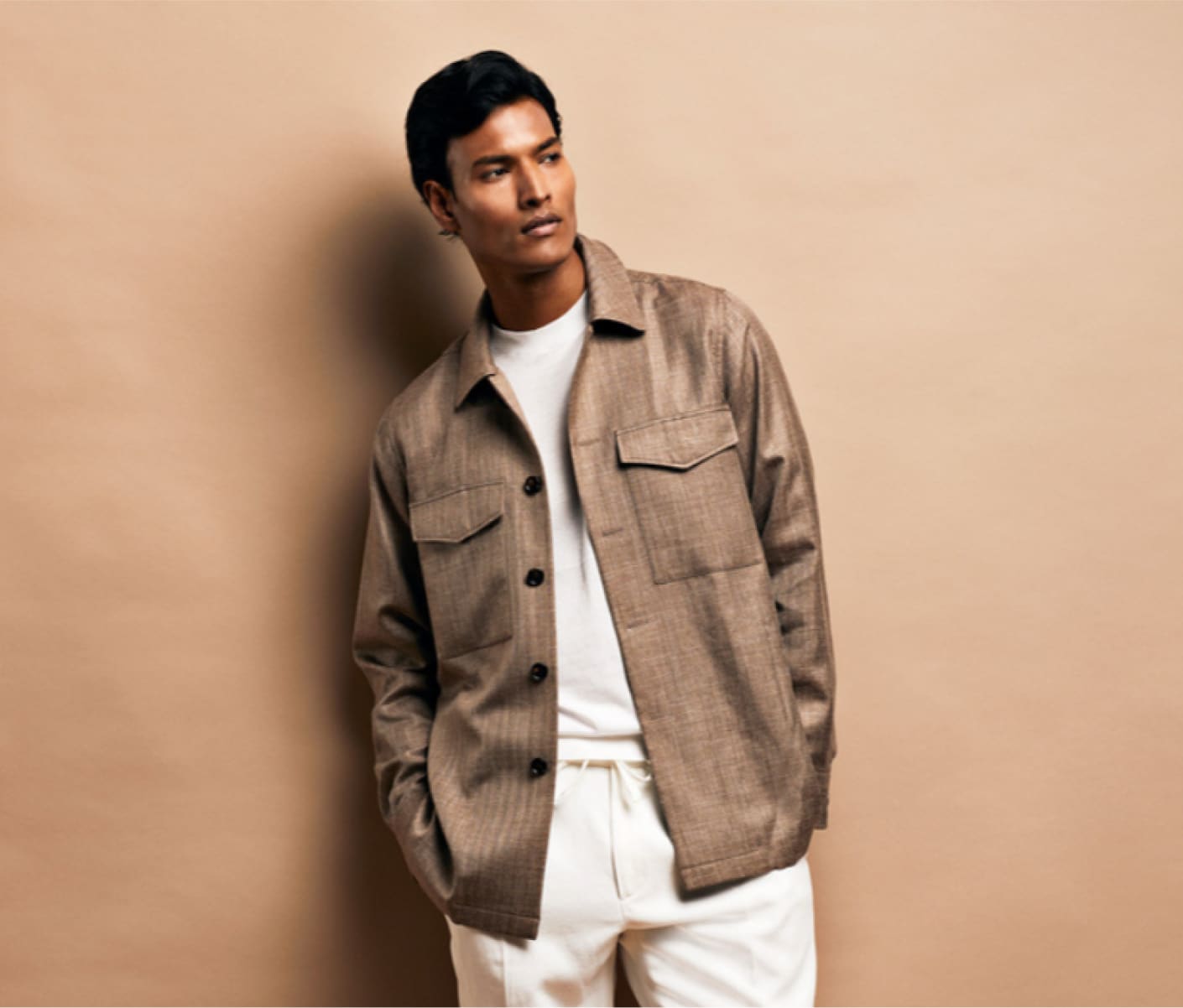 Model showcasing Deletto Milano tailored suit in a refined lifestyle scene