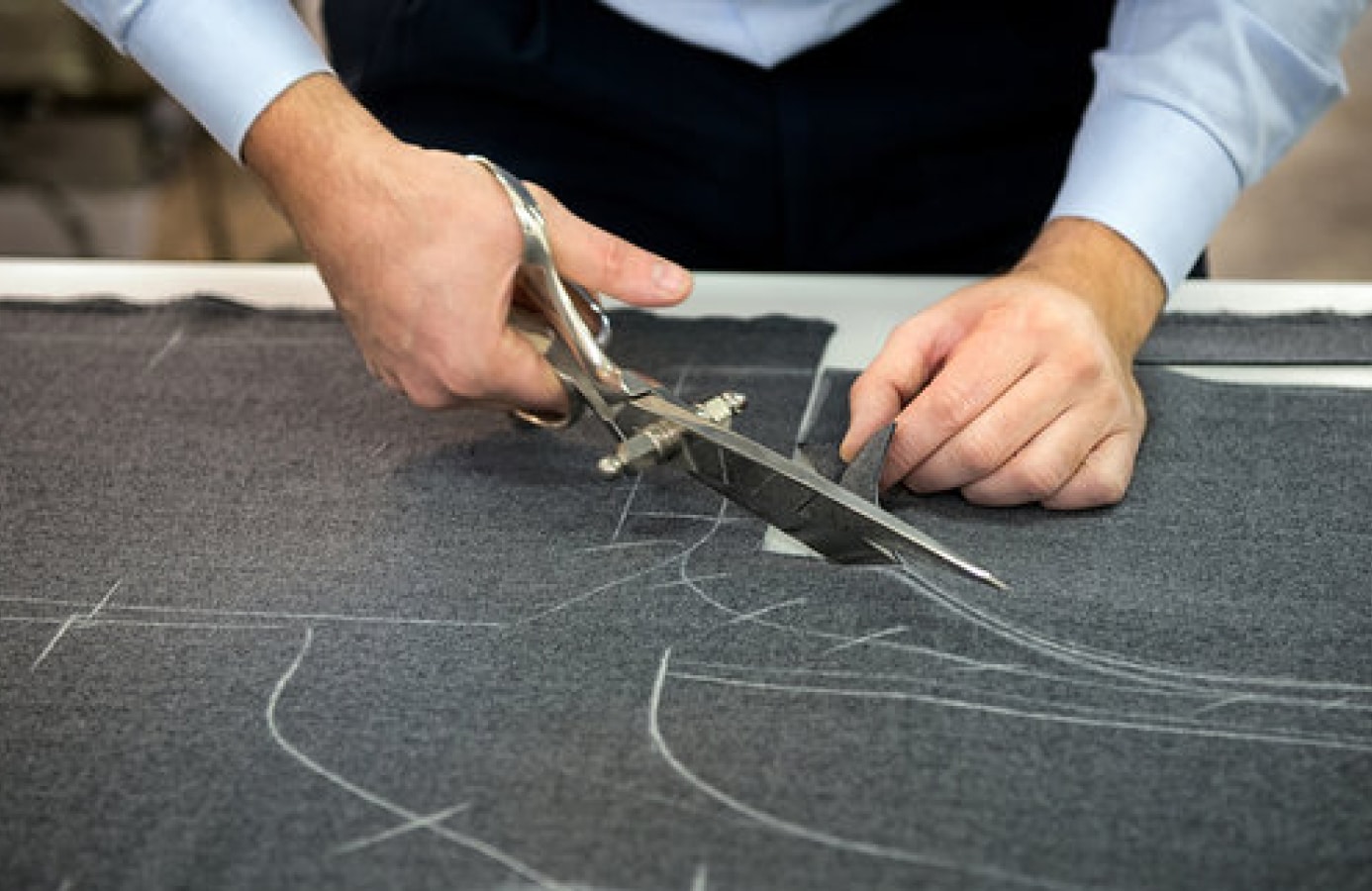 Craftsman preparing fabric for Deletto Milano made-to-measure tailoring